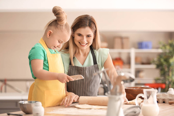 Mother and daughter with dough at table in kitchen - Foto, immagini