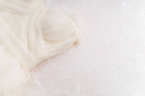 beautiful bridal dress on pastel background, close-up, wedding concept  - 写真・画像