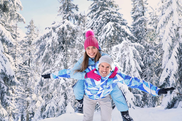 Happy couple having fun in snowy countryside. Winter vacation - Foto, Imagem