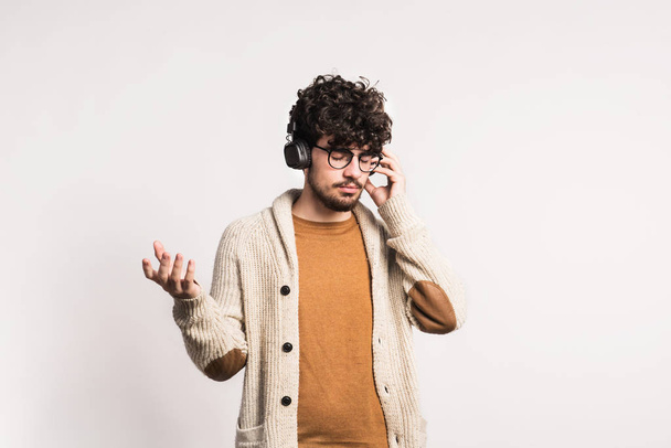 Portrait of a young man with headphones in a studio. - Photo, image
