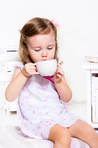 Child having tea - Фото, изображение