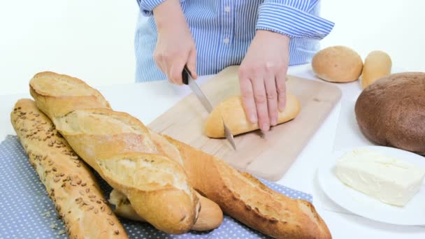 Fresh bread slice and cutting knife on rustic table. With wooman hands - Footage, Video