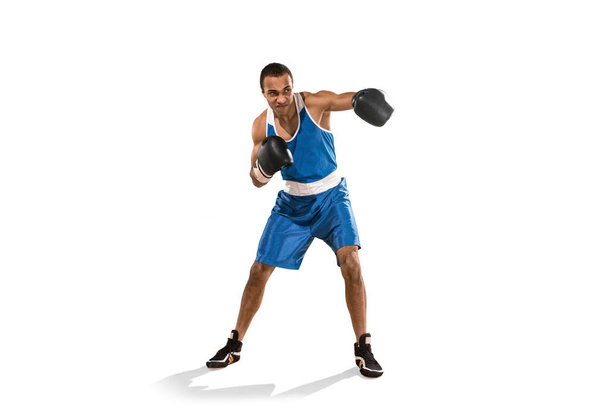 Sporty man during boxing exercise. Photo of boxer on white background - Photo, image