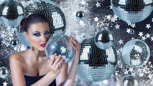 Young woman with disco balls - 写真・画像