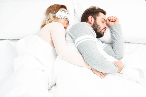 Young couple sleep together in bed - Photo, image
