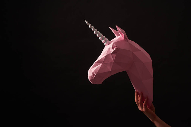 Pink paper unicorns head on black background. - Фото, зображення