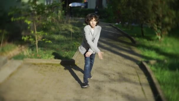 4k. beautiful stylish boy teenager dancing in a city park. - 映像、動画