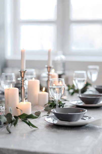 Wedding or festive table setting. Plates, wine glasses, candles and cutlery - Foto, Imagen
