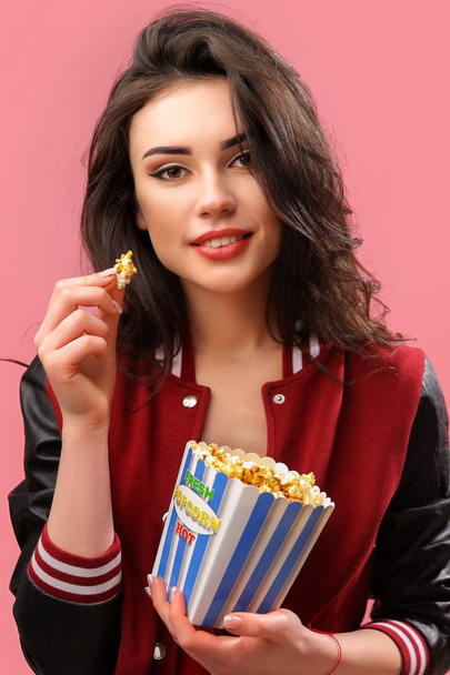 Playful girl with pack of popcorn - Fotó, kép