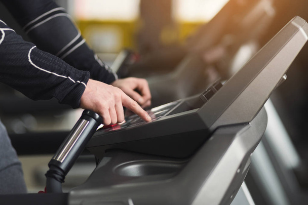 Unrecognizable man in gym running on treadmill - Photo, Image