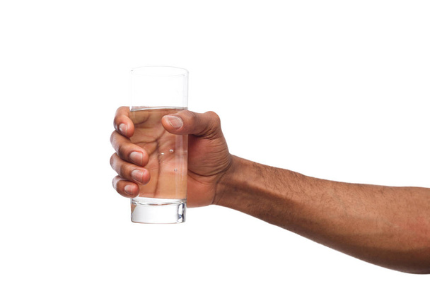 Black male hand holding glass of water isolated on white - Foto, immagini
