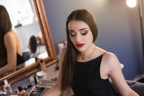 Portrait of beautiful woman with bright makeup indoors - Fotó, kép