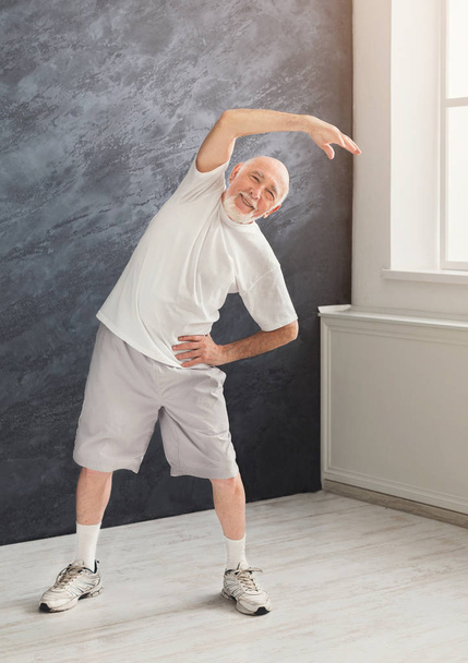 Senior man warmup stretching training indoors - Photo, image