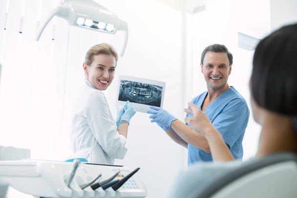 Delighted dentists showing teeth on the screen - Foto, Bild