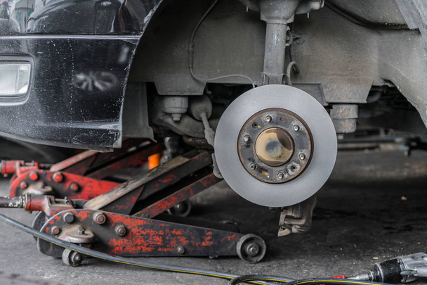 disc brake repair and wheel assembly at service station - Photo, Image