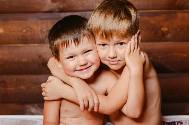 two happy boys on wooden background - Zdjęcie, obraz