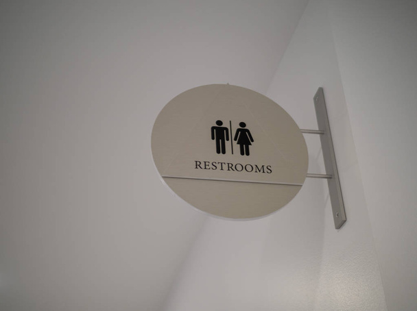 Women/men steel, modern restroom sign hanging high - Photo, Image