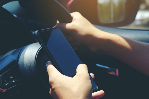 Close-up of hands holding smartphone in the car interior, blank  - Photo, Image
