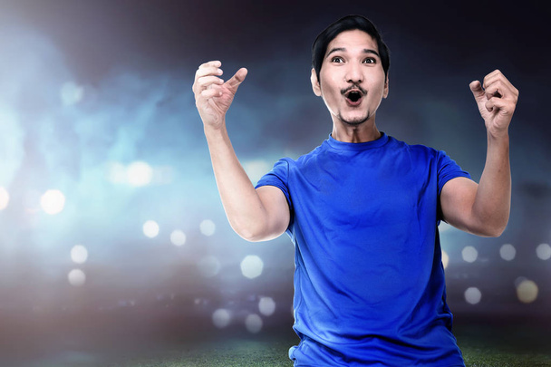 asian soccer player celebrating victory on field - Photo, image