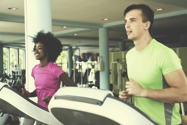 people exercisinng a cardio on treadmill in gym - Photo, Image