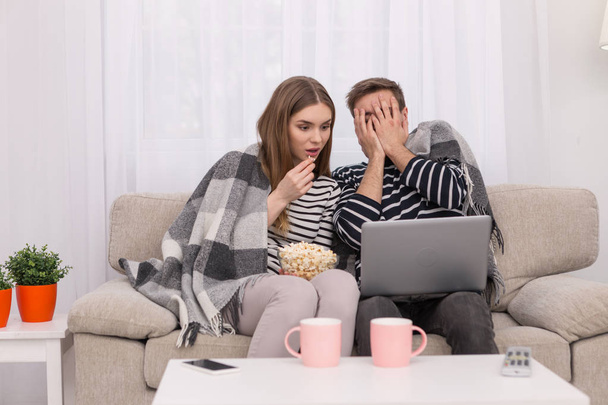 Excited woman and man watching a film - Foto, imagen