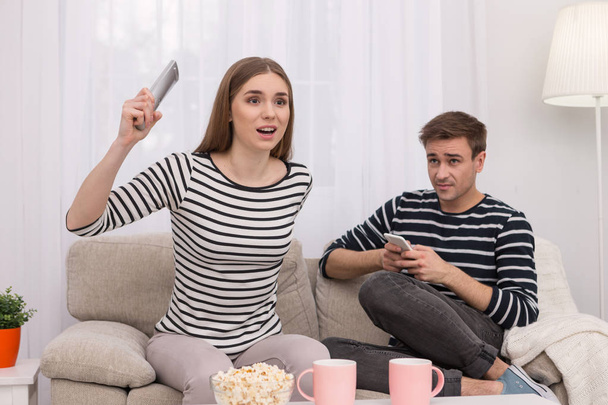 Overwhelmed woman watching a film with her boyfriend - Foto, Bild