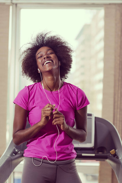 afro american woman running on a treadmill - Photo, image