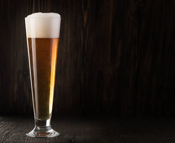 Glass beer on wood background with copyspace - Фото, изображение