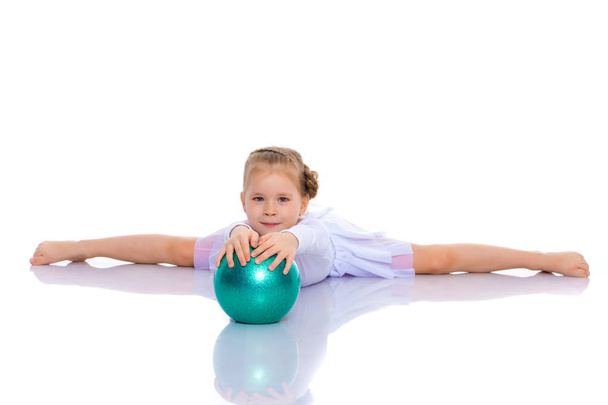 little girl is engaged in fitness with a ball. - Fotó, kép
