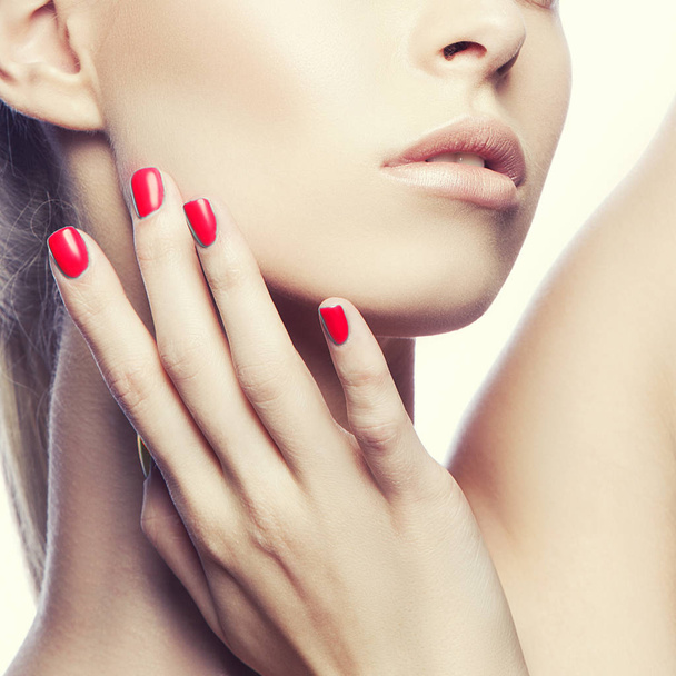Cropped portrait of young woman with natural makeup and red nail polish - Foto, Imagem