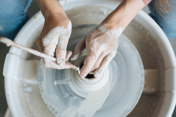 Handcrafted on a potter's wheel,Hands make clay from various items for home and sale in the store and at the exhibition, ceramic items are made in hand, the clay billet becomes a ceramic dish - Фото, зображення