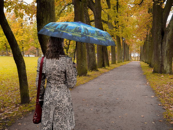 Woman with umbrella in the Park. - Zdjęcie, obraz