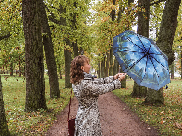 Woman with umbrella in the Park - 写真・画像