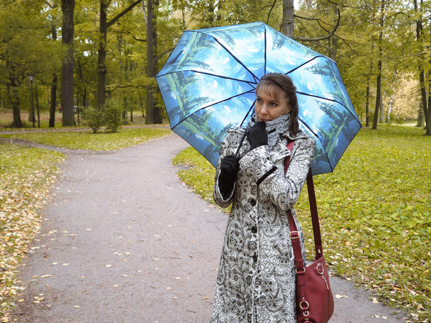 Woman with umbrella in the Park - Фото, зображення