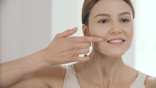 Beauty. Closeup Of Beautiful Female Model Applying Stripe Of Liquid Foundation On Fresh Facial Skin. Portrait Of Mature Woman Putting On Tonal Cream Base On Face. Cosmetic Concept. High Resolution - Materiał filmowy, wideo