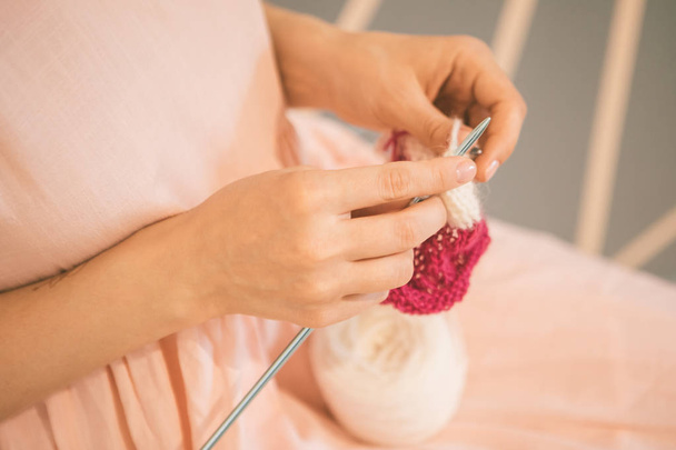 Lovely knitting Womens hands, Relaxed pink colored mood hobby. enjoyable leisure meditation - Photo, image