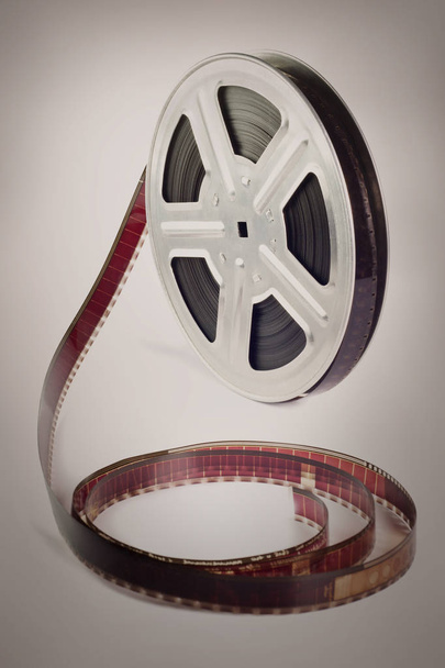Old motion picture film reel on brown background - Photo, Image