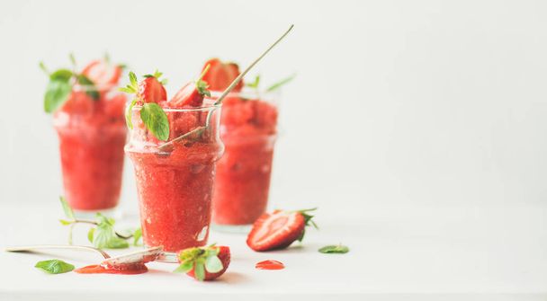 Healthy low calorie summer treat. Strawberry and champaigne granita, slushie or shaved ice dessert in glasses, white background - Φωτογραφία, εικόνα