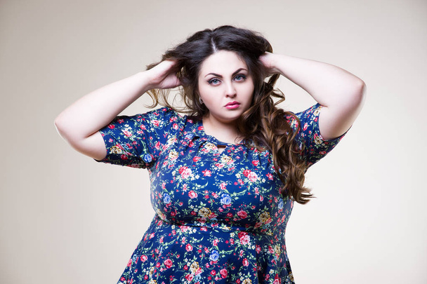 Plus size fashion model in casual clothes, fat woman on beige background, overweight female body - Фото, изображение