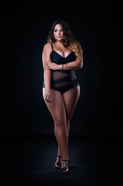 Plus size sexy fashion model in lingerie, fat woman on black studio background, overweight female body - Foto, afbeelding