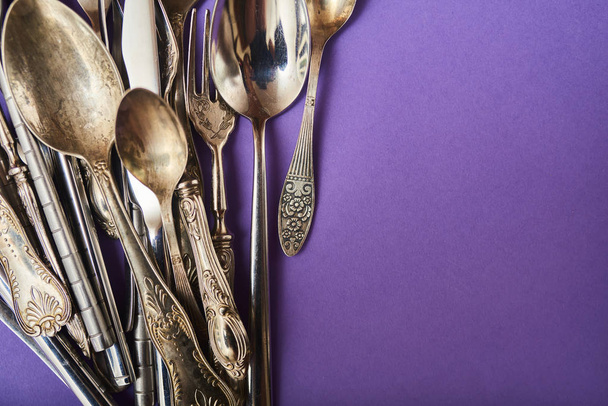 Closeup of cutlery set on bright colored background with place for text - Photo, Image