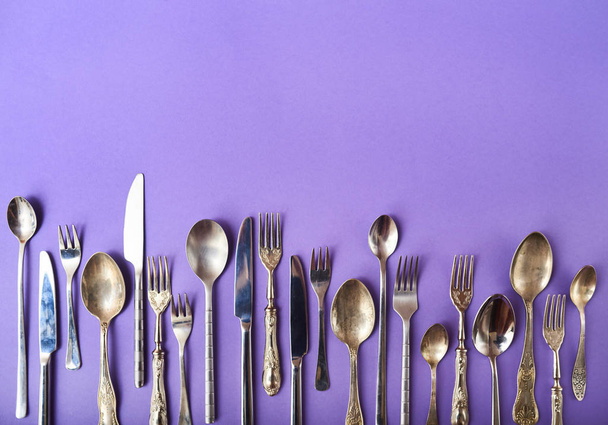 Closeup of cutlery set on bright colored background with place for text - Photo, Image