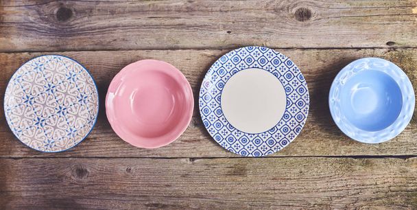 Set of different colorful dishes over wooden board background - Photo, Image
