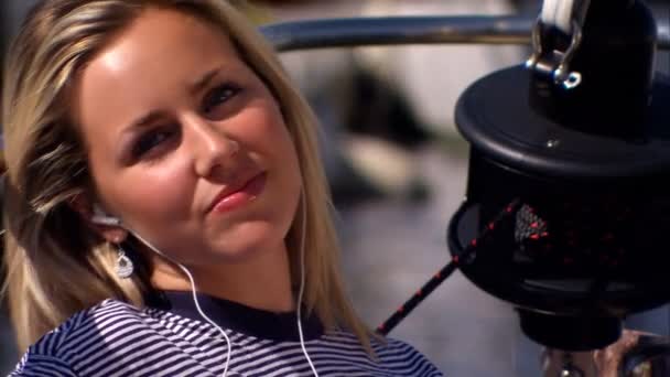 Hermosa joven rubia escuchando su reproductor de MP3
 - Metraje, vídeo