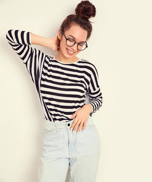 Portrait of young beautiful brunette woman girl model with nude makeup in glasses in summer hipster clothes posing near wall. Going crazy  - Valokuva, kuva