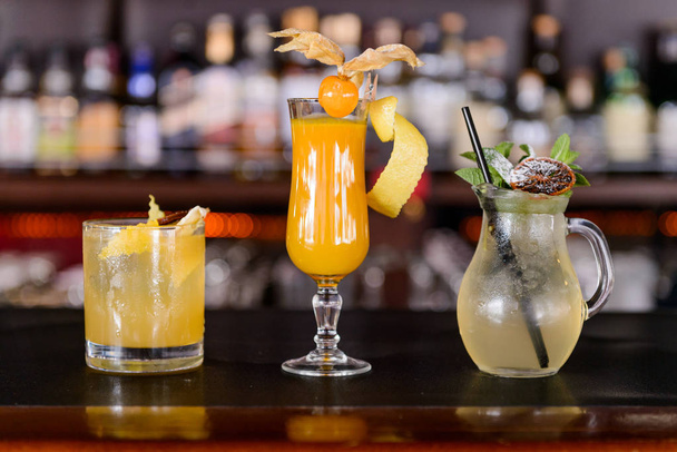 Fresh cocktail juice made of oranges and other summer fruits - 写真・画像