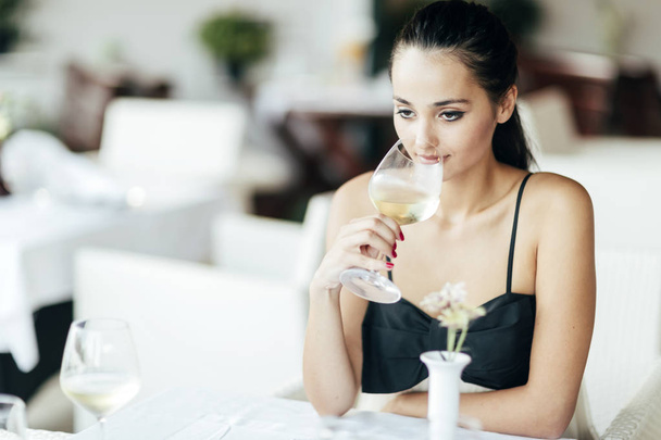 Attractive woman smelling the wine before degustation - 写真・画像