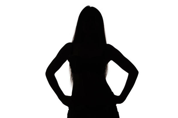 Silhouette of girl with hands on hips - Photo, Image