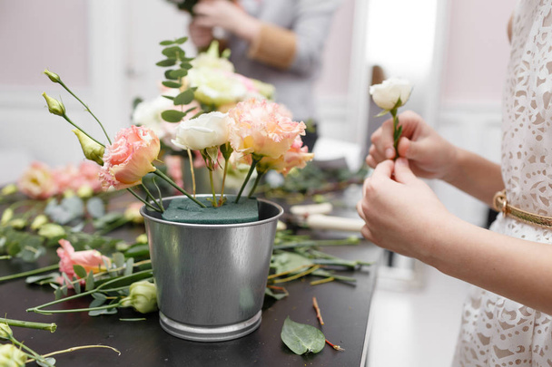 Master class on making bouquets for kids. Spring bouquet in metal ornamental flowerpot. Learning flower arranging, making beautiful bouquets with your own hands - Foto, Imagen
