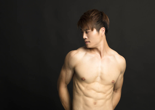 muscular young man isolated on black background - Photo, Image